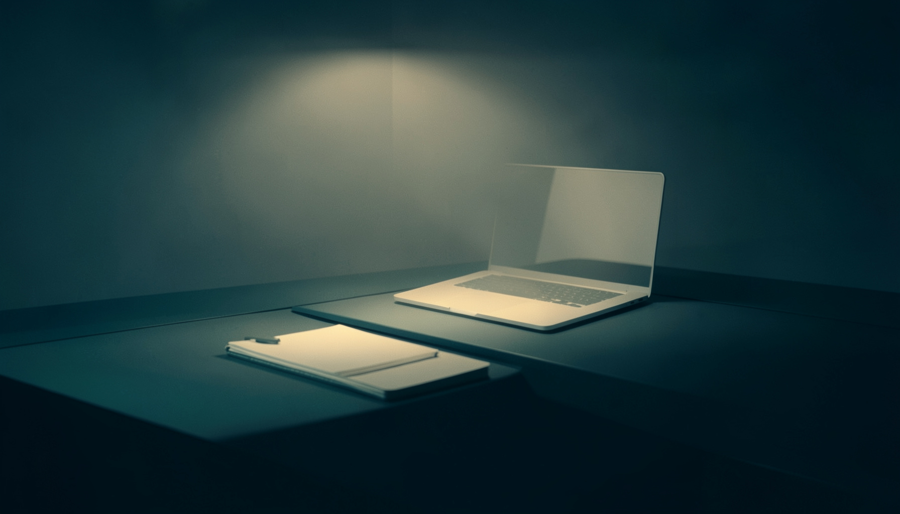 Duotone image of a sleek modern office desk in deep teal and warm cream tones, with soft overhead light casting a calm, contemplative mood over a notebook and a softly glowing laptop screen.